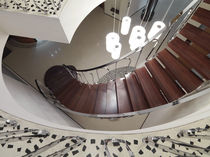 circular floating staircase in wood and steel Scala su misura in palissandro CHIAVARI s.r.l.