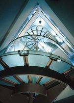 half-turn staircase with a lateral stringer for commercial buildings (metal frame and glass steps) BLOOMBERG SS 333 SPIRAL Stairs