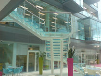 half-turn staircase with a lateral stringer for commercial buildings (metal frame and glass steps) SPENCER DOCK SS 668 SPIRAL Stairs