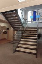 half-turn staircase with a lateral stringer for commercial buildings (metal frame and wooden steps) HANOVER SQUARE SS 636 SPIRAL Stairs