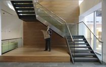 half-turn staircase with a lateral stringer for commercial buildings BAKER STREET SS 700 SPIRAL Stairs