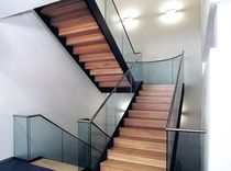 half-turn staircase with a lateral stringer for commercial buildings (metal frame and wooden steps)  Nautilus