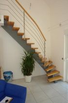 quarter-turn staircase with a central stringer (metal frame and wood steps) MH Schmidt Escaliers