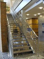 straight staircase with a lateral stringer for commercial buildings (metal frame and steps)  Couturier Iron Craft