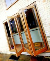 wooden fold-and-slide patio door RUBBEN BESPOKE Rubben UK