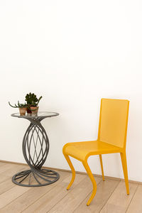 contemporary chair / perforated sheet metal / yellow