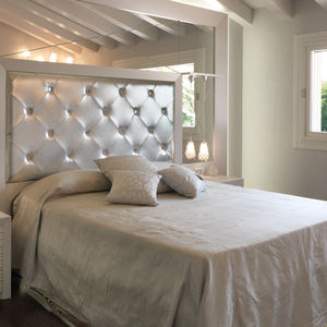 double bed / contemporary / with upholstered headboard / leather