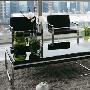 contemporary armchair / leather / stainless steel / cantilever