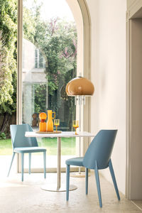 contemporary chair / molded plywood / upholstered / with armrests