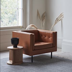 contemporary armchair / leather / fabric / brown