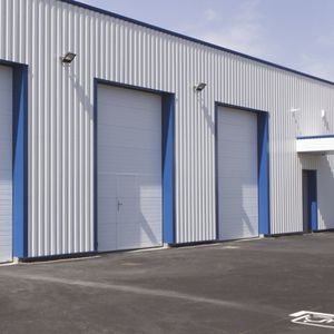 sectional industrial doors / steel / automatic / semi-glazed