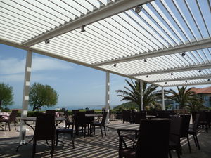 wall-mounted pergola / aluminum / with mobile slats / bioclimatic