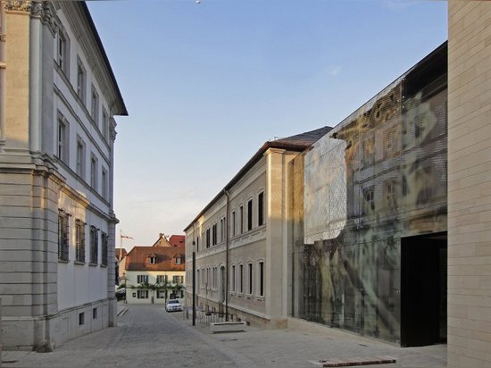 reiner john links historic building to new extension with glass façade