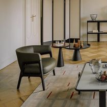 Contemporary armchair / leather / fabric...