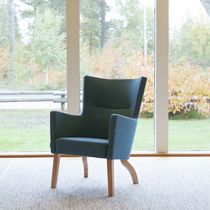 Contemporary armchair / leather / fabric...