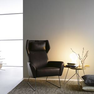 contemporary armchair / leather / with footrest / wing