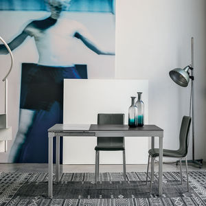 contemporary dining table / tempered glass / painted metal / laminate