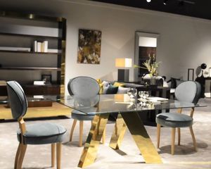 contemporary dining table / tempered glass / MDF base / polished brass base