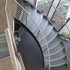 Quarter-turn concrete staircase with solid wood steps