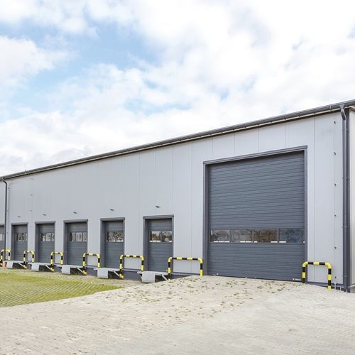 Sectional industrial door - MakroPro 100 2.0 series - WISNIOWSKI - metal / automatic / security