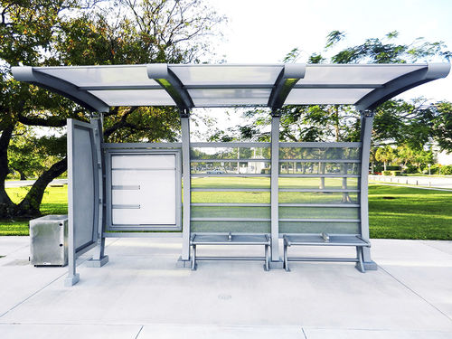 Aluminum bus shelter - CURVED I-BEAM INTERLUDE - Brasco International Inc. - tempered glass / polycarbonate / with bench