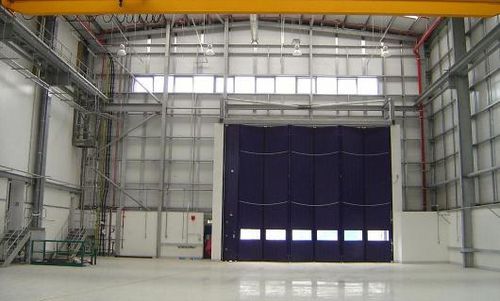 Industrial folding door - ESAVIAN : TYPE 1200 - Jewers Doors - aluminum / waterproof / for hangar
