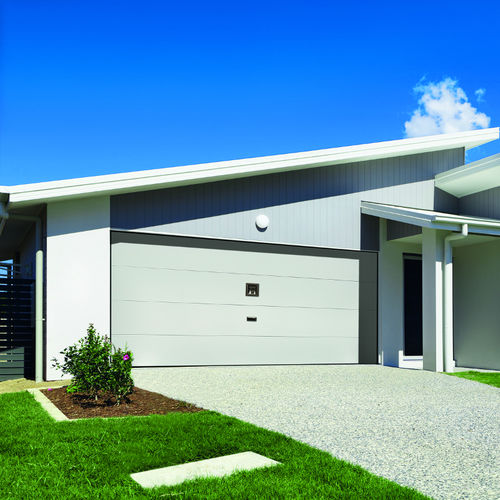 Overlap garage door - WAVE - Delta Overlap - sheet steel / polyurethane foam / automatic