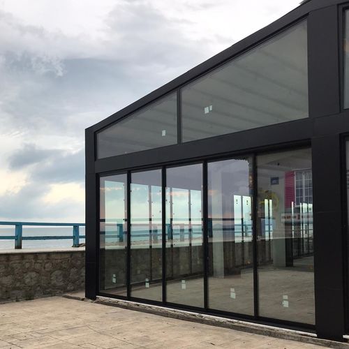 Sliding and stacking patio door - WITH THRESHOLD - BKS balcony glazing systems - aluminum / 3 leaves / double leaf