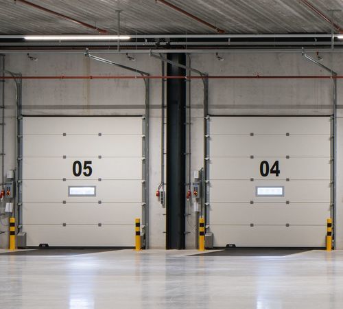 Sectional industrial door - CRAWFORD OH1142P DUAL DRIVE - ASSA ABLOY Entrance Systems - steel / thermally-insulated / automatic