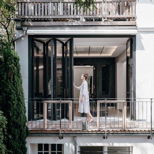 Sliding patio door - HIGHLINE - SOLARLUX - bi-fold / wooden / aluminum