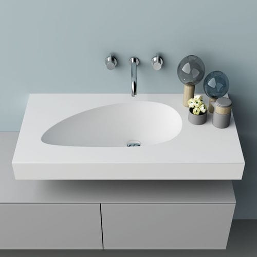 Integrated washbasin - WING - PLANIT - Corian® / with counter / curved