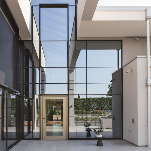 Exterior door - NOVA - Oikos Venezia - glass / aluminum / pivoting