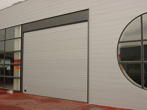 Sectional industrial door - Angel Mir – Portes Bisbal - steel / acoustic / for public building