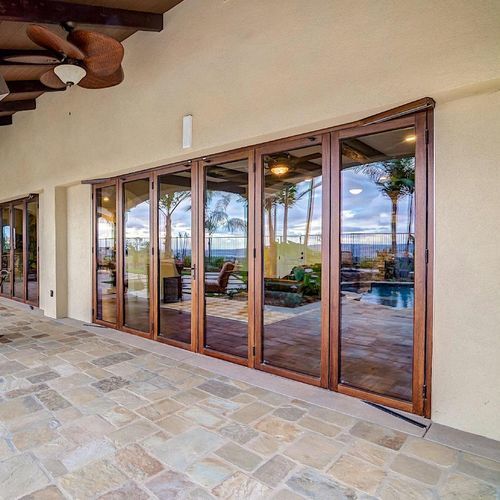 Sliding and stacking patio door - WD65 - NanaWall - folding / wooden frame / double-glazed