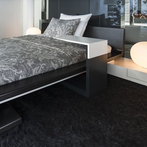 Contemporary side table - SLIDER - Steininger Designers - Corian® / solid wood base / melamine base