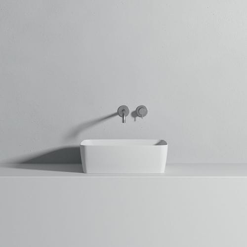 Countertop washbasin - Rexa Design - Corian® / rectangular / without hole