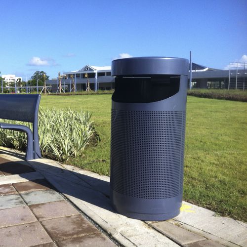 Public trash can - PETOSKEY - landscapeforms - metal / with built-in ashtray / hooded