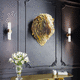 brass sculpture / wall-mounted / golden / black