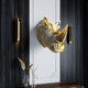brass sculpture / wall-mounted / golden / black