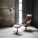 contemporary armchair / leather / fabric / with footrest