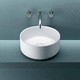 countertop washbasin / Corian® / round / without hole