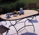 contemporary table / teak / metal base / oval