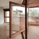 pivoting patio door / wooden / aluminum / double-glazed