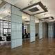 sliding and stacking partition / pivoting/sliding / mobile / with glass panel