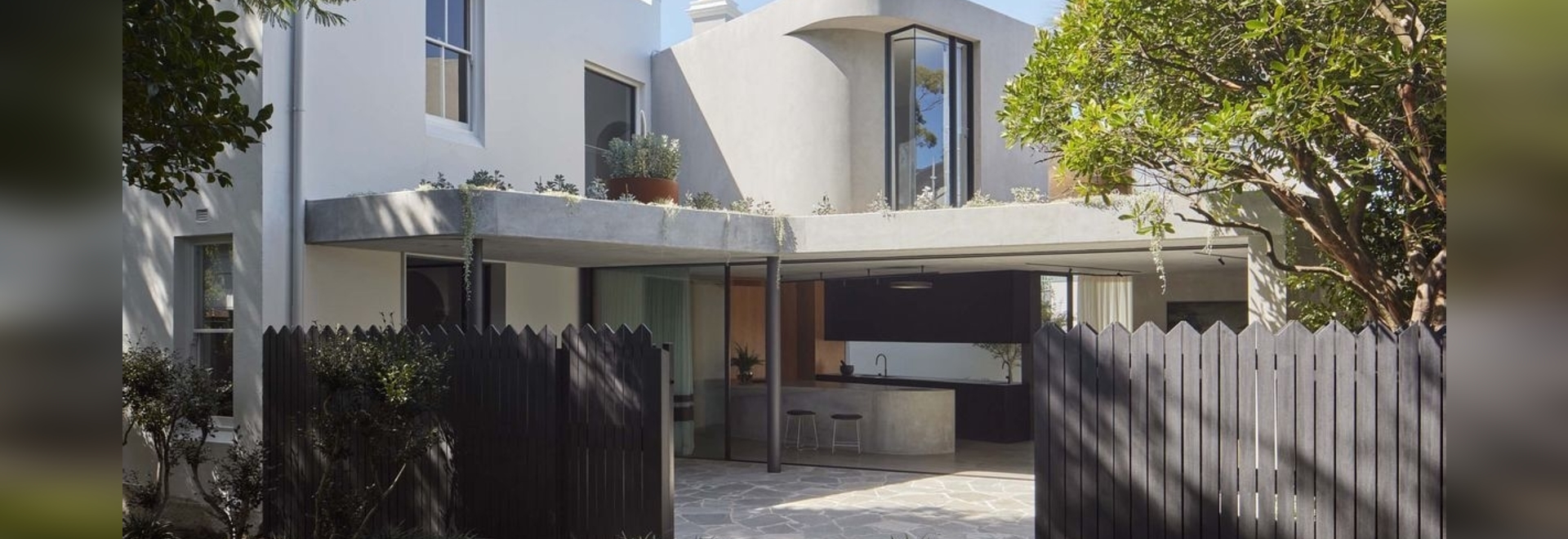 The addition reorients living spaces to open onto a semi-private grove adjoining the site's western edge.