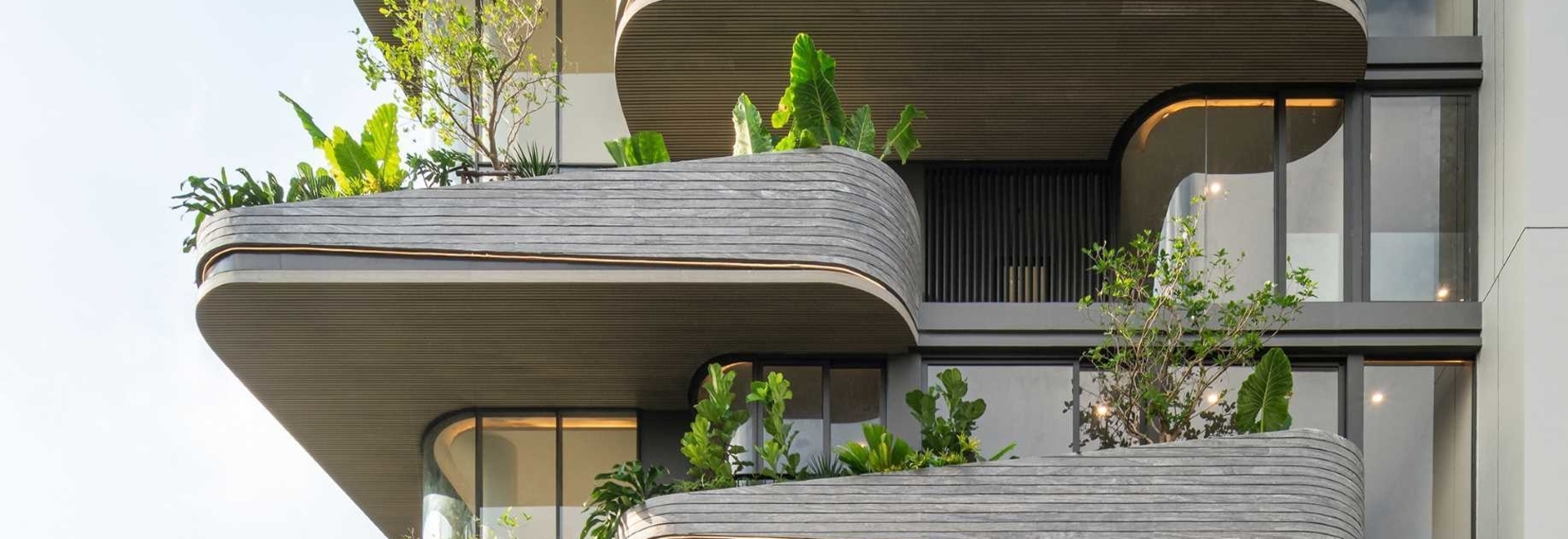 Lighting Is Used To Highlight The Rounded Balconies Of This Building