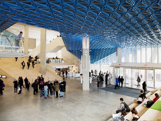 a large canopy is clad in iridescent, hand-folded metal panels