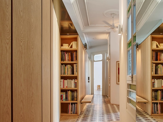 Built Architecture uses oak cabinetry to reorganise a mosaic-floored Barcelona apartment