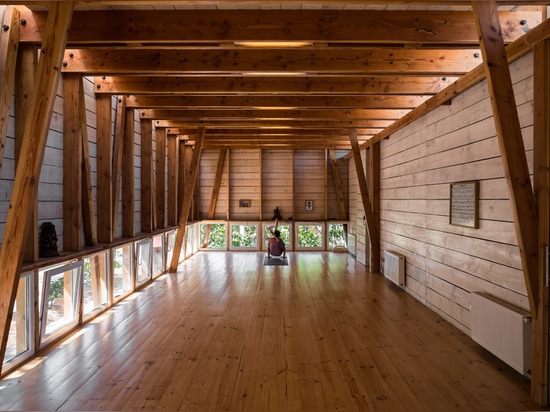 DX Arquitectos extends yoga teacher's house with a blackened timber studio on top