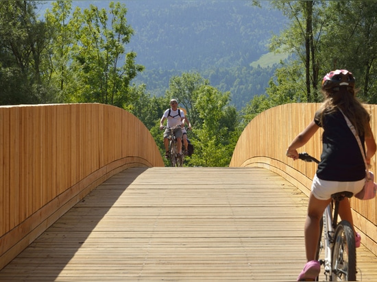 Arching wooden footbridge by DANS Architects connects Slovenian village to mountains